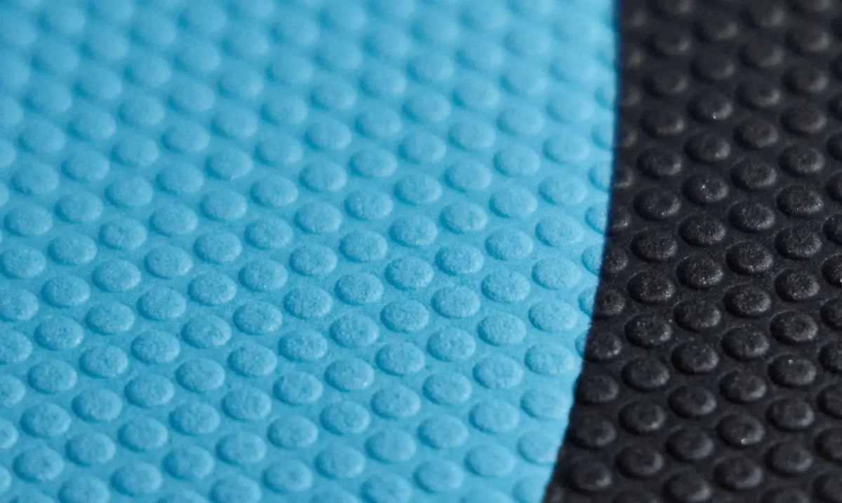 Close-up of hydrofoil board deck grip in moulded EVA texture in black and ocean blue