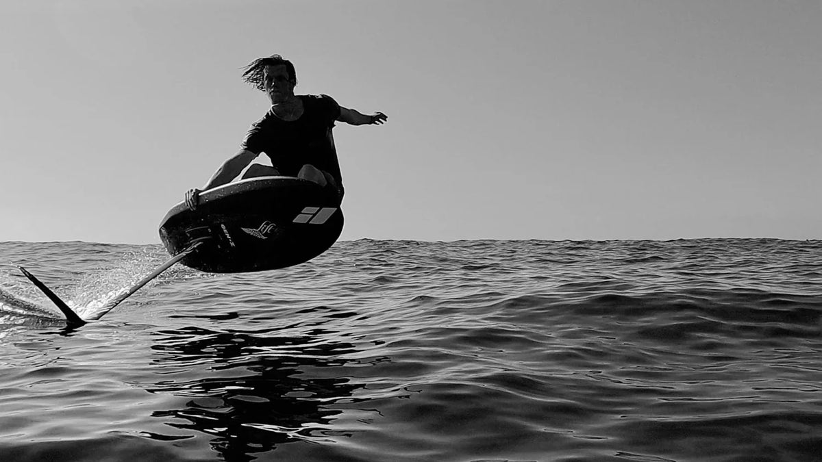 Amos Shapes carbon foilboard with Lift Foils on the water