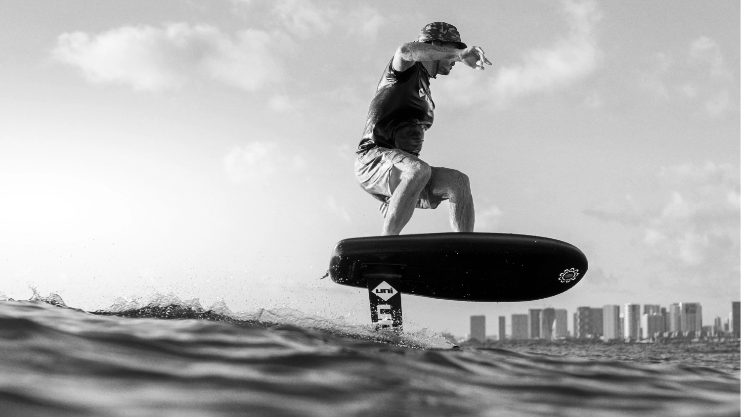 Adam riding a Majek Foil board