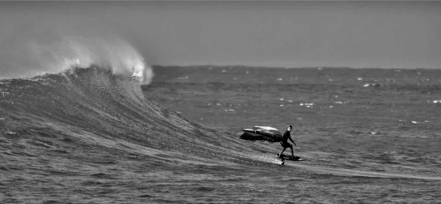 A foiler riding an Amundson Customs foilboard